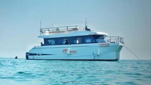 A white yacht with the name "AARMAAR" and "MTDC" logos, sailing on calm waters. - Blue Sea Beach Resort (Malvan)