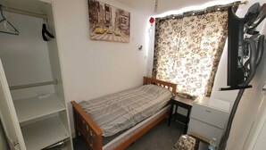 A small, compact bedroom with a single bed, a desk, and a wardrobe. - Kosy Roomz  - Rooms Only (Welling)