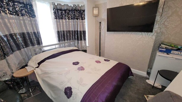 A bedroom with a bed, a desk, a chair, a TV, and curtains. - Kosy Roomz  - Rooms Only (Welling)