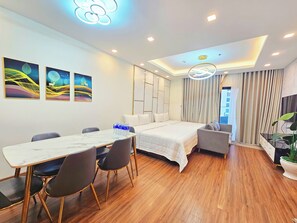 Deluxe Suite, 3 Bedrooms | Living area | 52-inch Smart TV with cable channels - FLC Sea Tower - Apartment Quy Nhon (Quy Nhon)