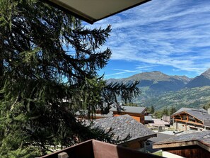A mountainous village with traditional wooden buildings and a clear view of the surrounding landscape.