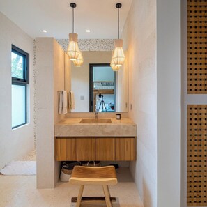 A modern bathroom with a large mirror, wooden vanity, and pendant lights. - Seasons at Ceiba (Hacienda Pinilla)