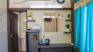 A compact bathroom with a sink, mirror, and shelves for toiletries. - Gems9 Airport Hotel (Nedumbassery)