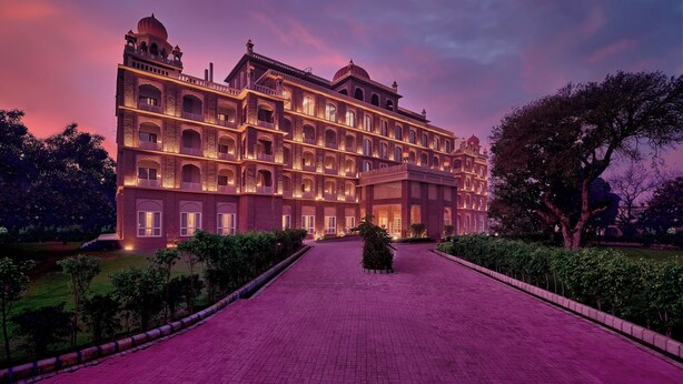 A large, multi-story building with a central courtyard, arched windows, and a dome on the top. - Sarovar Premiere Amritsar (Amritsar)