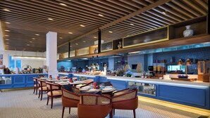 A modern restaurant with a long counter, wooden ceiling, and patterned floor. - Sarovar Premiere Amritsar (Amritsar)