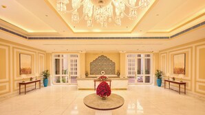 A spacious lobby with a marble floor, a reception desk, and a chandelier. - Sarovar Premiere Amritsar (Amritsar)
