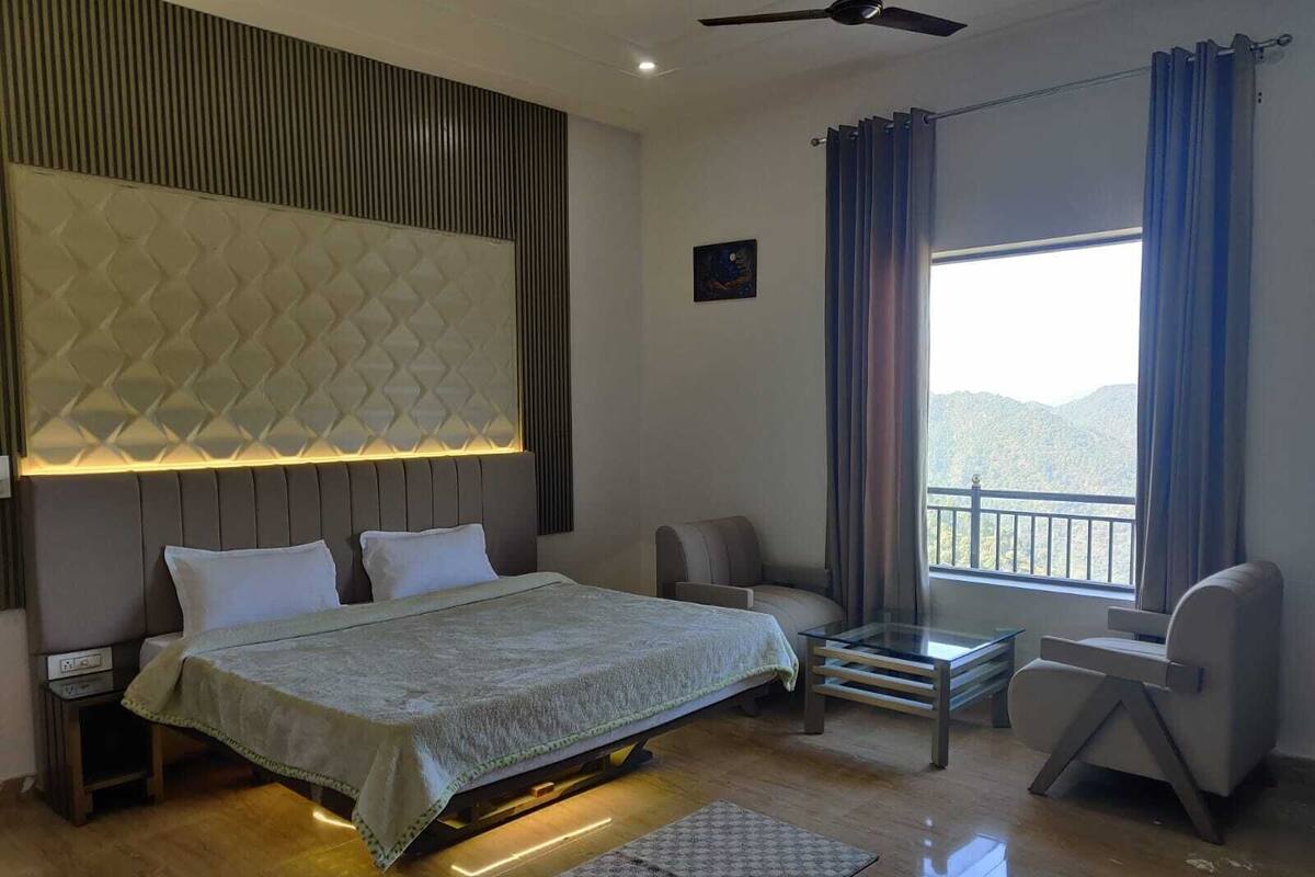A modern bedroom with a bed, a desk, and a chair.