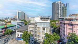 A cityscape with modern high-rise buildings, a mix of commercial and residential structures, and a clear sky. - Redenza Suites Makati (Makati)