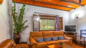A cozy living room with a sofa, a coffee table, and a television. - Beautiful home in Priego De Cordoba (Priego De Cordoba)