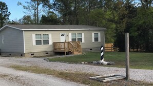 A single-story house with a front porch and a mailbox.