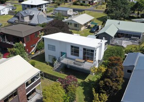 Experience a serene retreat with a spacious front yard and a balcony offering a peaceful outdoor space.
