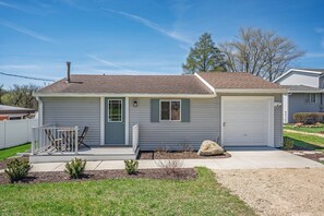 A single-story house with a front porch, a garage, and a small front yard. - Lake WI Escape! Explore, Boat, Swim & Hike (Lodi)