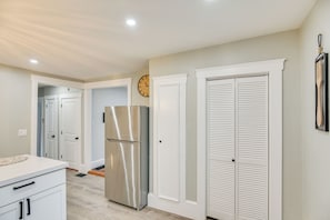 A modern kitchen with white cabinetry, a stainless steel refrigerator, and a clock on the wall. - Sharon Home < 8 Mi to Gillette Stadium! (Sharon)