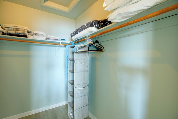 A neatly organized closet with hanging space and shelves for folded clothes. - Pet-friendly Maryland Home on the Potomac River! (Leonardtown)