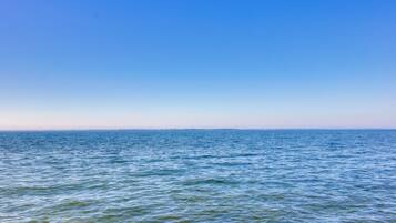 A calm sea under a clear sky.