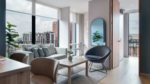 A modern living room with a view of the city, a dining area, and a large mirror. - w Spectacular Loft w Balcony in El Nogal (Bogotá)