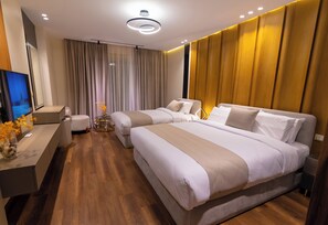 A modern hotel room with two beds, a desk with a TV, and a large window with curtains. - Spire West Hotel (Giza)
