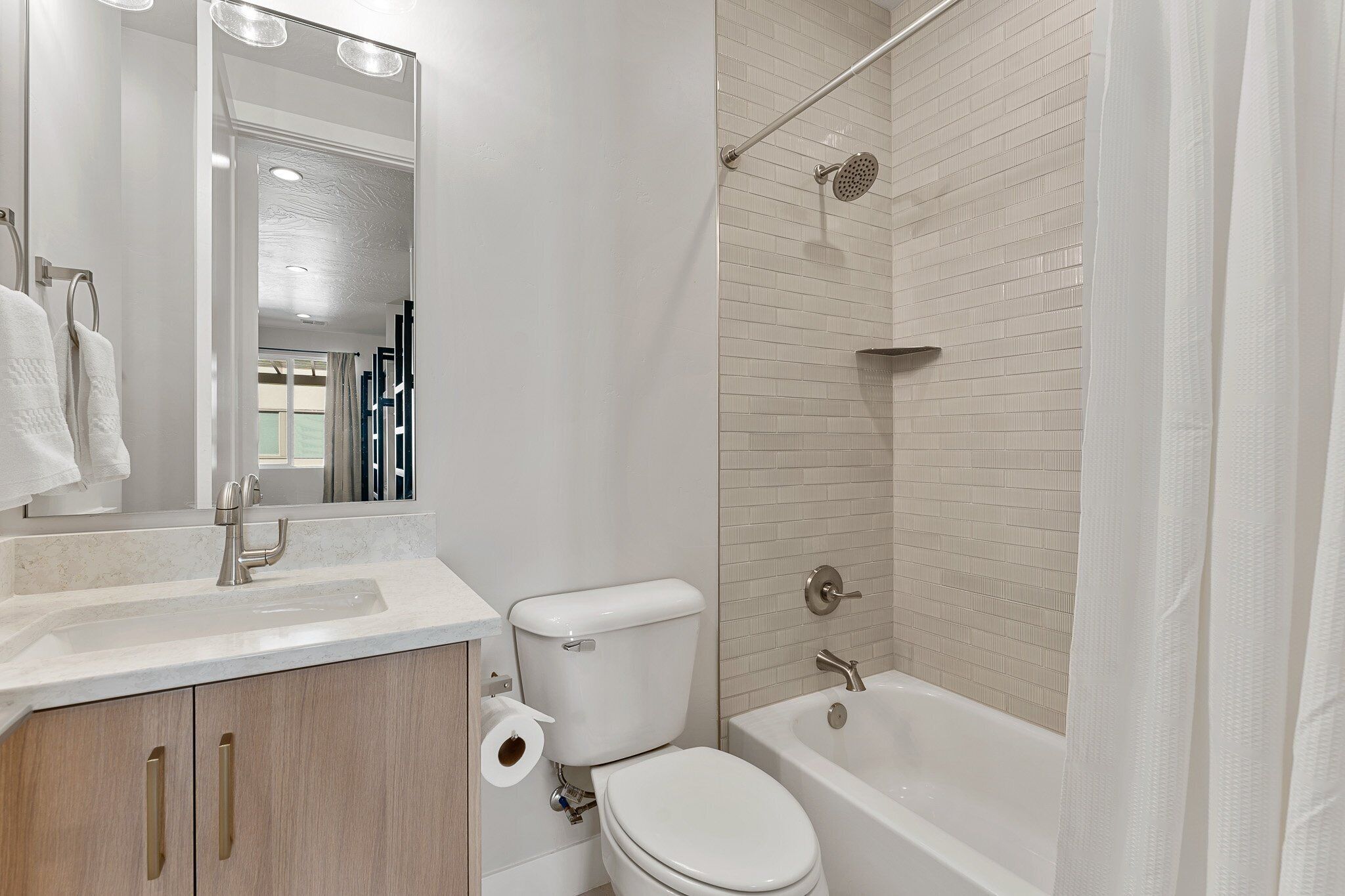 A bathroom with a toilet, sink, and bathtub.