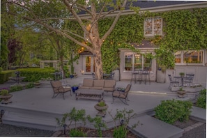 A covered patio with outdoor furniture, a pergola, and a dining area with a view of the house. - French Provencal Chateau in the Heart of Napa (Calistoga)