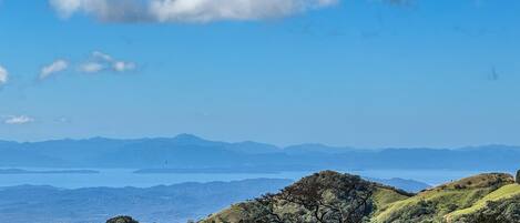A panoramic view of a mountainous landscape with a clear sky and distant mountains.