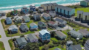 A coastal residential area with various houses and buildings, some with balconies and waterfront views. - Relax & Recharge at Paid Time Off (Surf City)