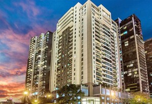 A high-rise building complex with multiple floors and balconies, likely a hotel or residential building. - Spacious City Road Haven (Southbank)