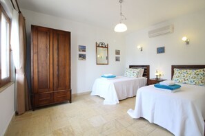 A hotel room with two beds, a wardrobe, a mirror, and wall-mounted lights. - Elena Is A Contemporary, Spacious Apartment Within The Stunning Elvina Complex (Kalkan, Antalya)