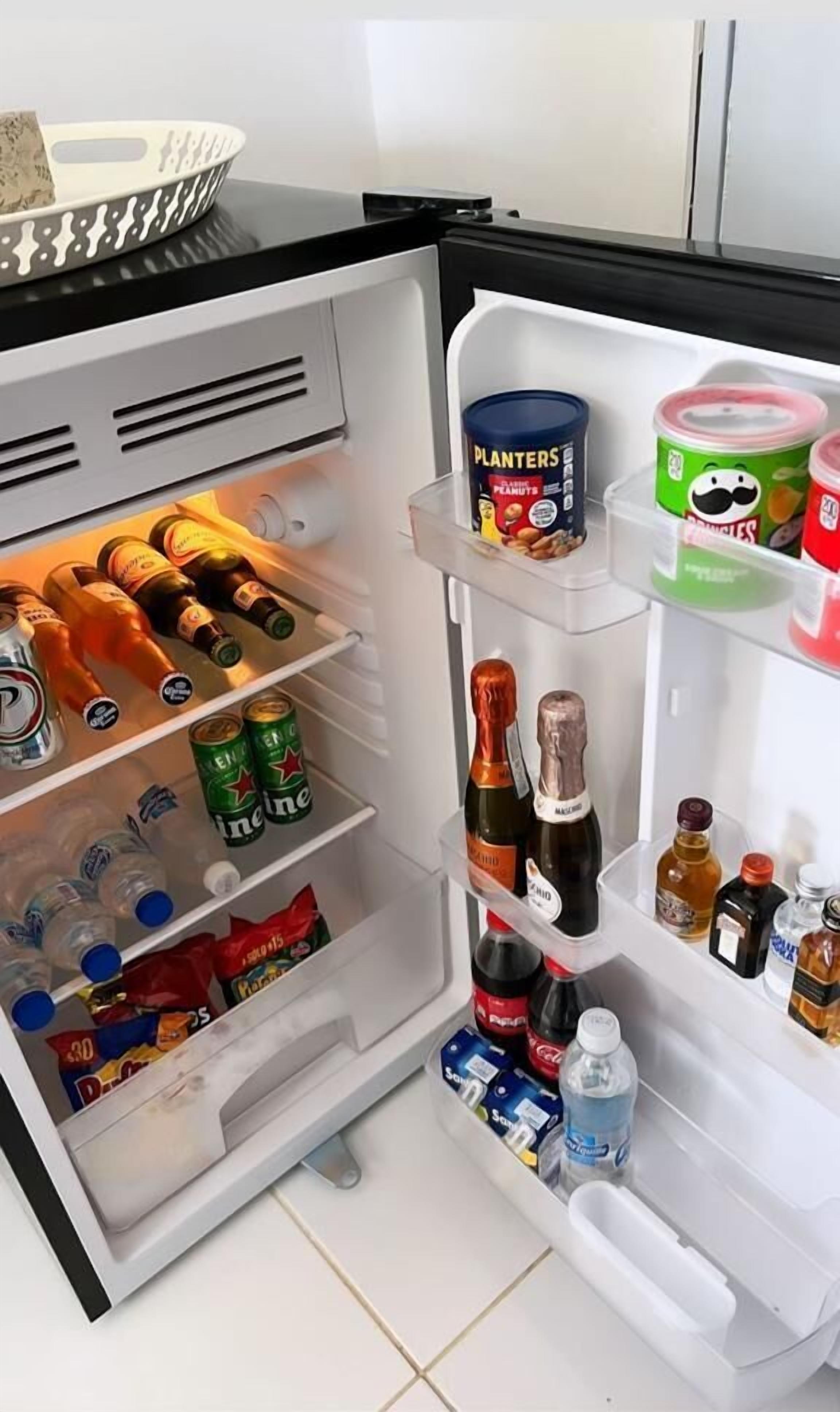 An open refrigerator with various food and drink items.
