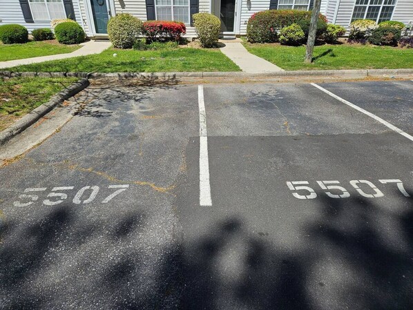 A parking lot with two marked spaces, each labeled with the number 5507.