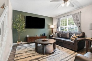 Living room with large TV and comfortable seating