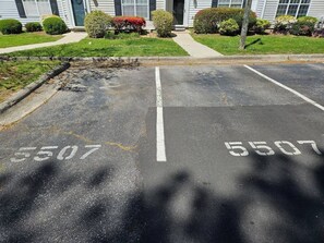 A parking lot with two marked spaces, each labeled with the number 5507.