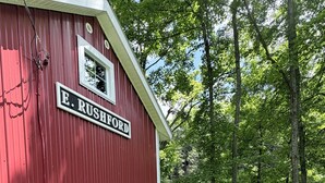Un edificio rojo con un letrero que dice 'E. RUSHFORD' y un muelle que se adentra en el agua.