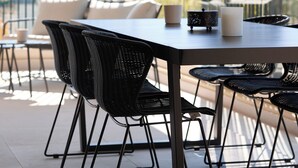 A terrace with a table and chairs, a sofa, and a railing. - The Samirah Luxury Residences (Elliniko-Argyroupoli)