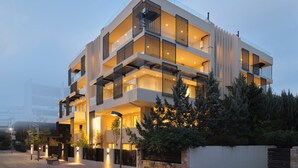 A modern multi-story building with balconies, large windows, and outdoor lighting. - The Samirah Luxury Residences (Elliniko-Argyroupoli)