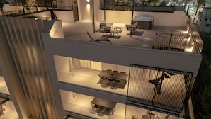 A multi-level outdoor terrace with seating, a hot tub, and a dining area. - The Samirah Luxury Residences (Elliniko-Argyroupoli)