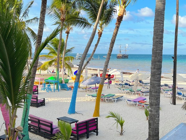 Private beach, white sand, sun loungers, beach umbrellas