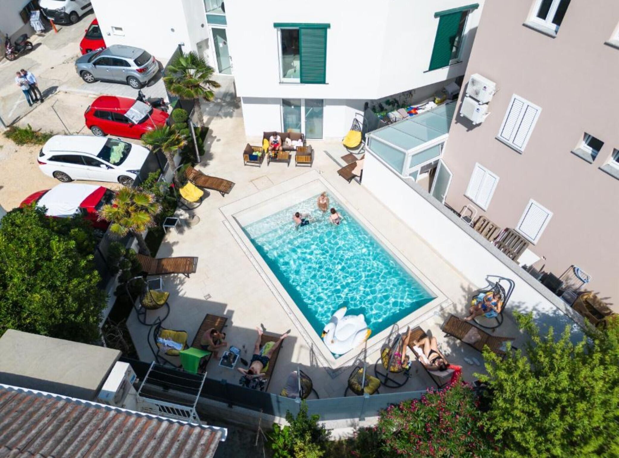 Une piscine sur le toit, dotée de chaises longues et d’un flotteur en forme de cygne.