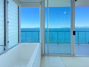 A balcony with a view of the sea and distant mountains. - 1 Bright Point Apartment 5101 (Nelly Bay)