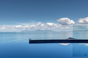 A clear view of the sea and distant mountains through a glass barrier. - 1 Bright Point Apartment 5101 (Nelly Bay)