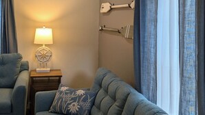 A living room with a sofa, a lamp, and curtains. - Modern NewlyFurnished Acadia Apt (Ellsworth)