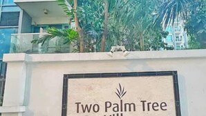 A sign for "Two Palm Tree Villas" with a palm tree logo. - Airport Condo across NAIA T3 (Pasay)
