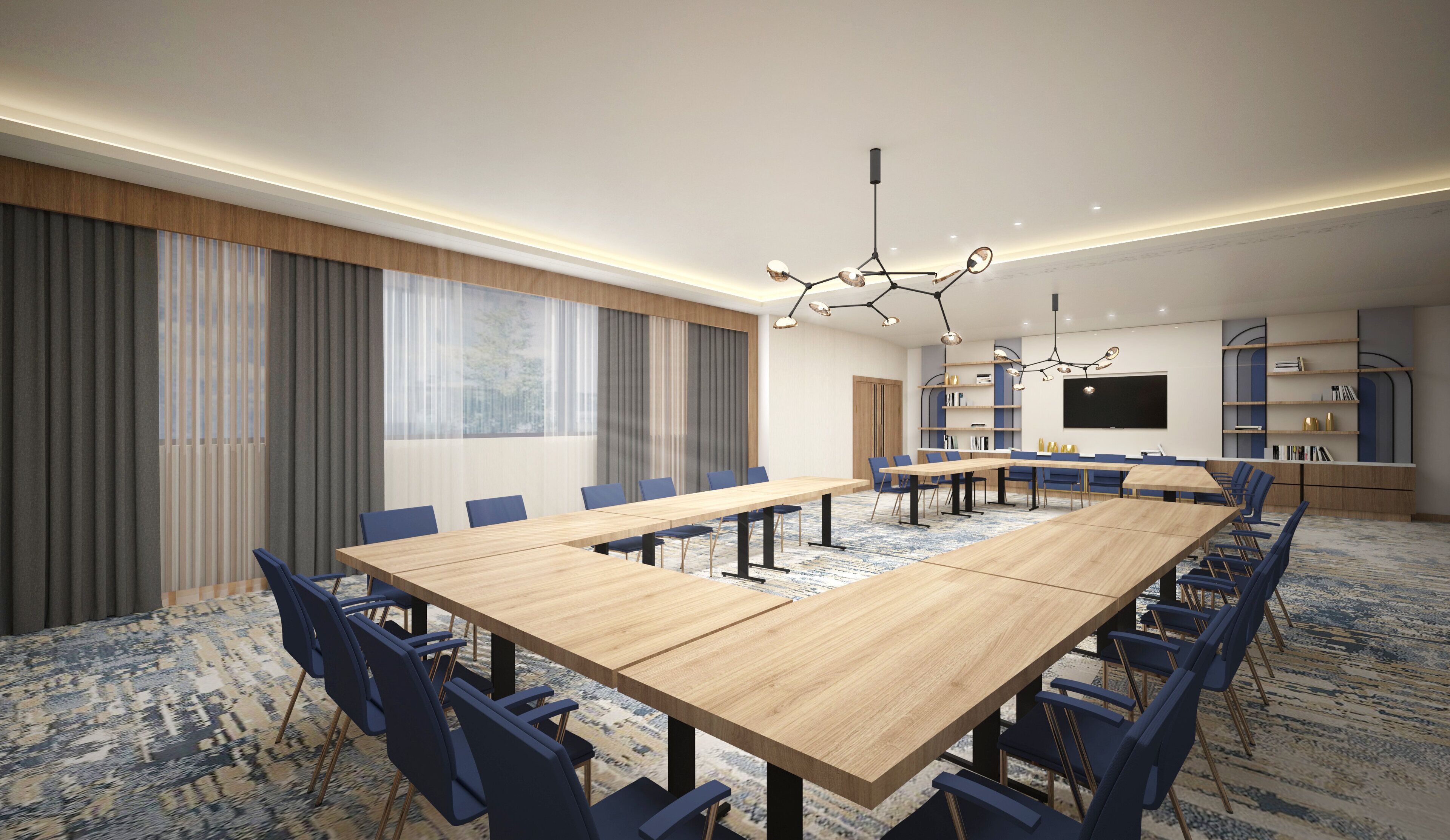 A conference room with a large table, chairs, a TV screen, and bookshelves.