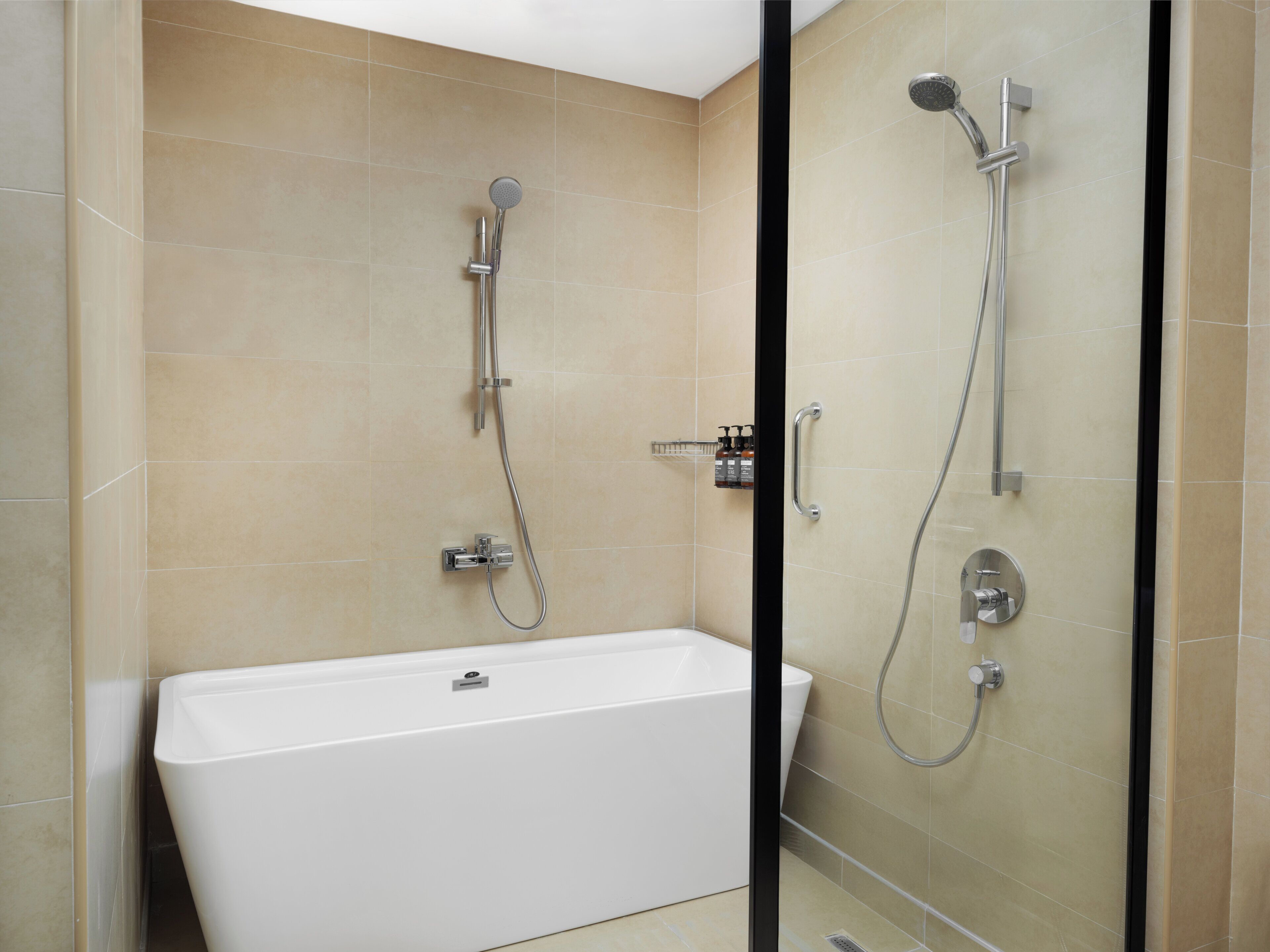 A modern bathroom with a freestanding bathtub, a handheld showerhead, and a wall-mounted showerhead.