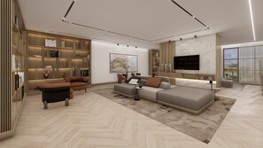 Relax in a spacious living room with a large sofa, coffee table, and armchair, featuring a bookshelf and flat-screen TV.
