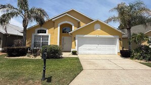 A yellow house with a garage, a mailbox, and palm trees. - Private Pool Villa, Many Updates! Southern Dunes (Haines City)