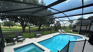 A backyard with a swimming pool, a hot tub, and outdoor furniture. - Beautifully Remodeled Home - Southen Dunes Golf Course Views (Haines City)