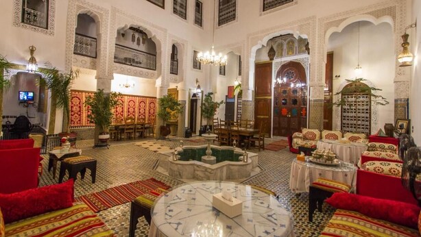 A spacious lobby with a fountain, seating areas, and traditional decor. - Riad Lalla Zoubida (Fes)