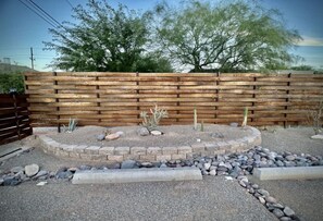 Stroll through the serene garden, surrounded by a variety of desert plants and a tranquil gravel bed.