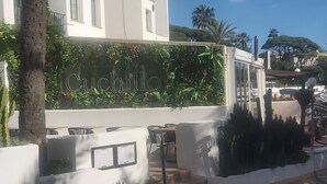 A building with a sign reading 'Cuchillo' and a staircase leading to an upper level. - Apartment 'Mi Patio, Port Of Cabopino' with Shared Pool, Wi-Fi and Air Conditioning (Unknown)
