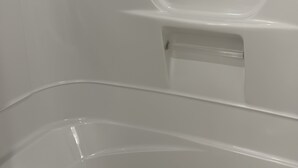 A clean, empty bathtub with a smooth surface and a single faucet. - Ashcroft Motel (Ashcroft)